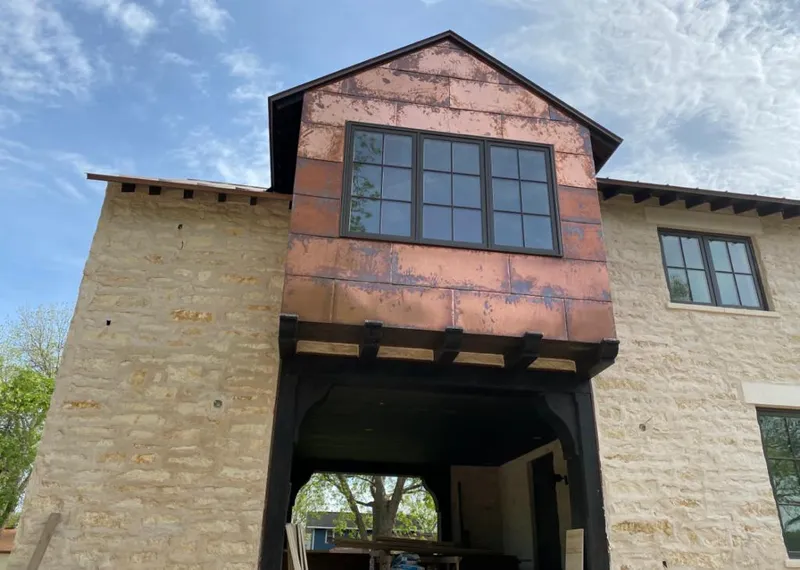 Copper metal panel facade on a stone building for Skylight Installation in Westborough